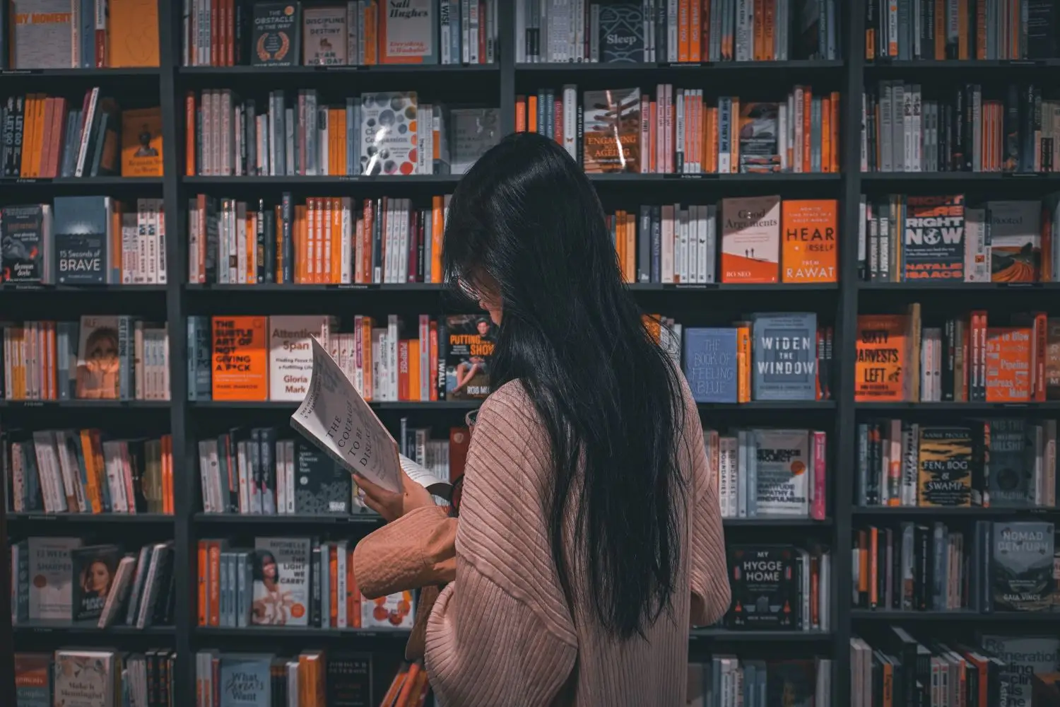 Reader browsing books in a library