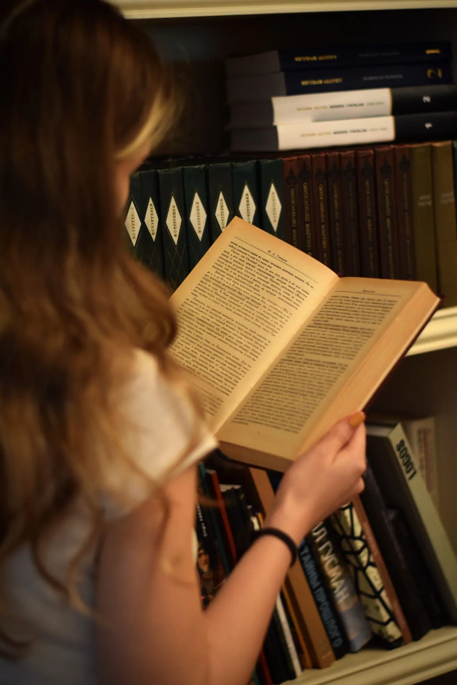 Reader holding an open book in warm light