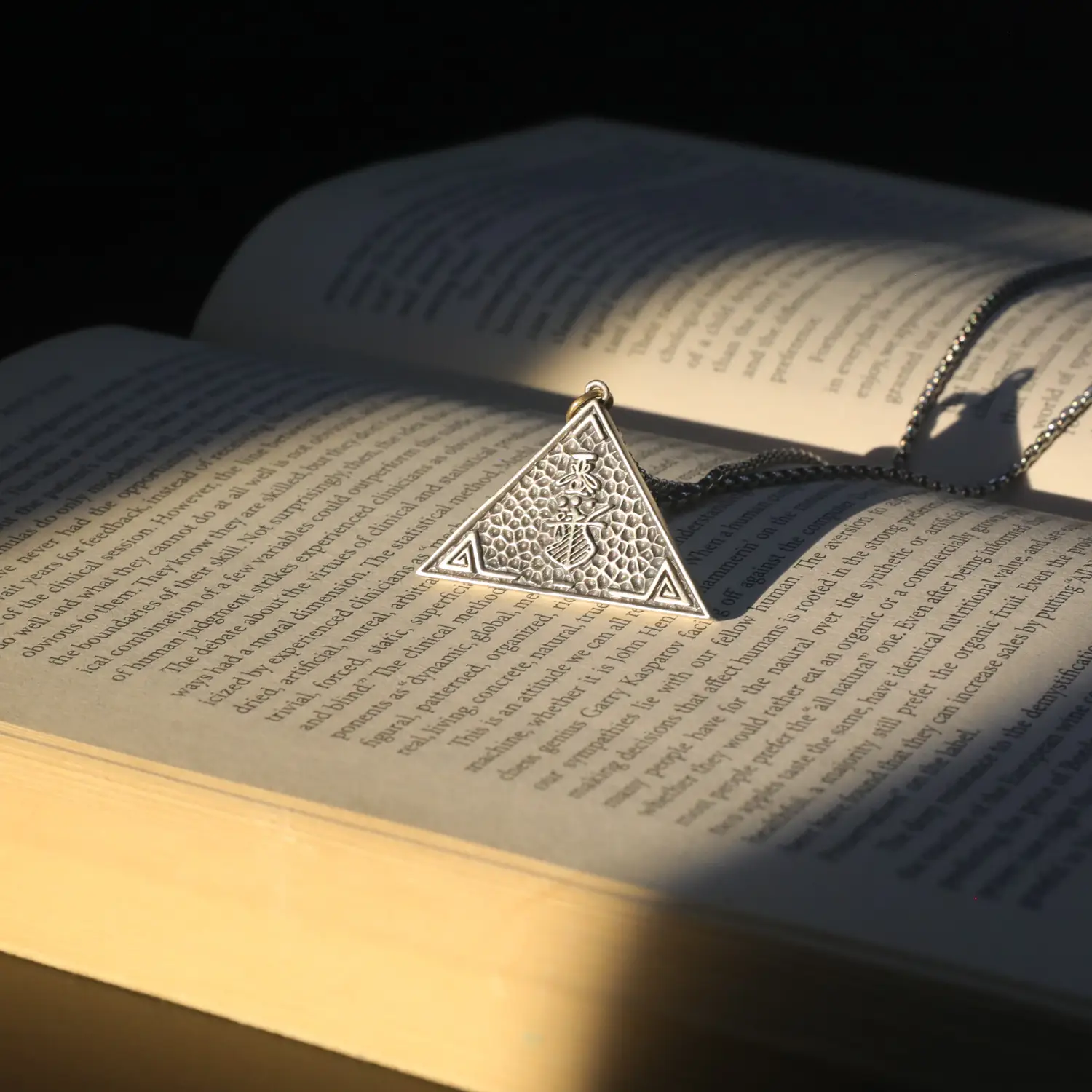 Bookmark casting a shadow across an open book